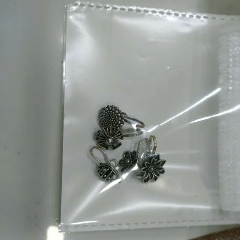 Discover the charm of our oxidized silver designer nose pins, specially crafted in a pack of 5 to enhance your ethnic beauty with elegance and style. Each nose pin features a unique design inspired by floral, geometric, and textured motifs that offer a rich antique silver finish, perfect for women and girls who appreciate minimal yet classy traditional jewelry. Made from premium quality oxidized alloy, these nose pins are lightweight, skin-friendly, and provide a comfortable fit for all-day wear. Whether for daily use, festive occasions, weddings, or gifting, these lightweight, comfortable nose pins securely grip and complement both ethnic and fusion outfits beautifully.